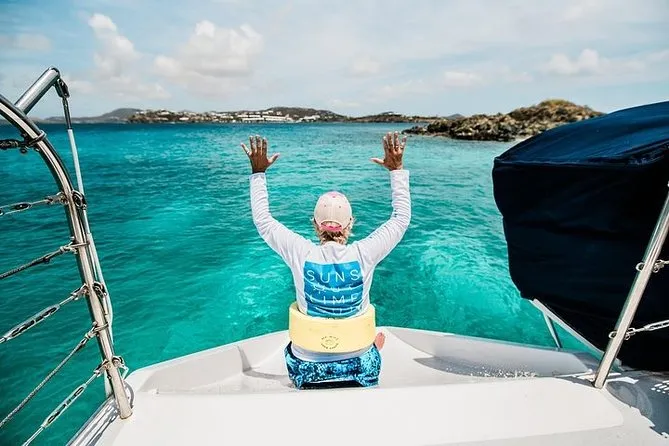 A sailing catamaran anchored in calm turquoise water near St. John USVI on a clear Caribbean afternoon — ideal conditions for snorkeling in St. John USVI year-round